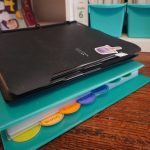 black flex note binder on top of blue Avery binder