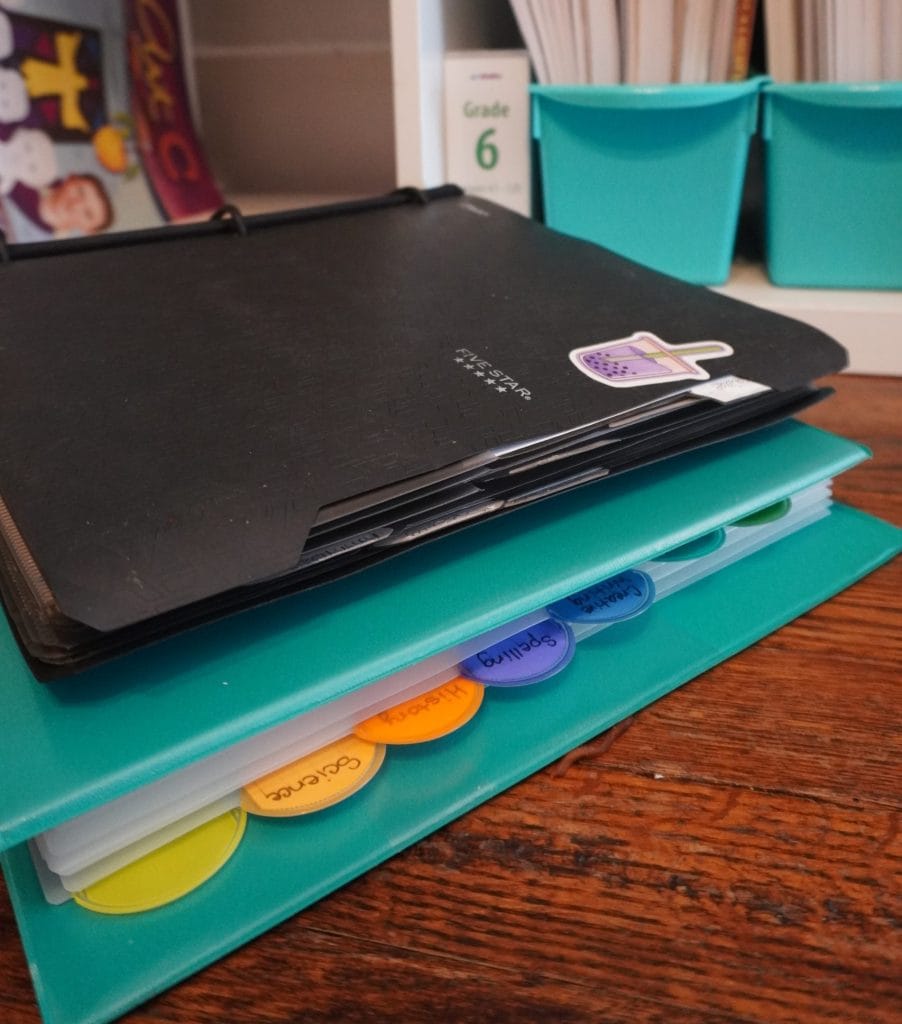 black flex note binder on top of blue Avery binder