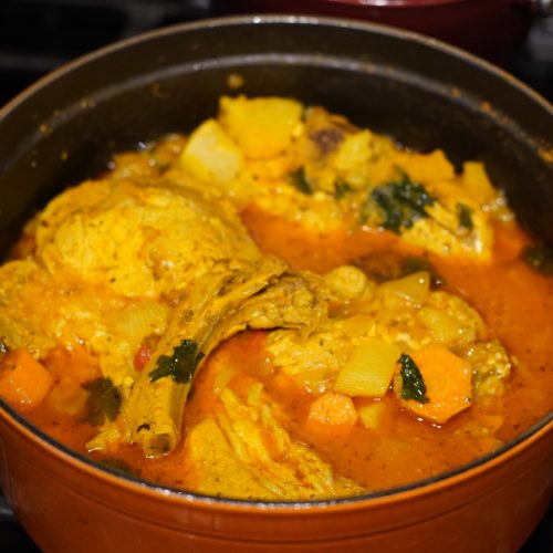 Puerto Rican Chuletas guisadas in an Orange dutch oven