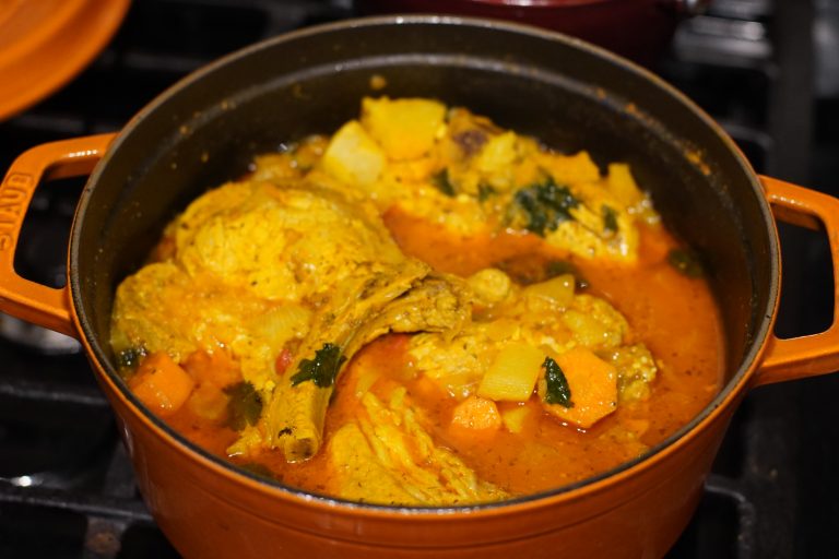 Puerto Rican Chuletas guisadas in an Orange dutch oven